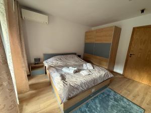 a bedroom with a bed with two towels on it at Nikol5 Deluxe in Velingrad +23 photos
