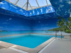 a swimming pool with a blue ceiling at Villa FOREST in Poznań