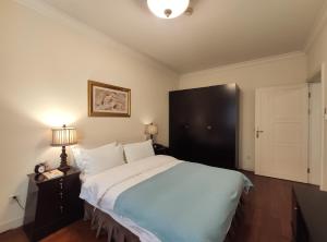 Postel nebo postele na pokoji v ubytování Ladoll Service Apartments