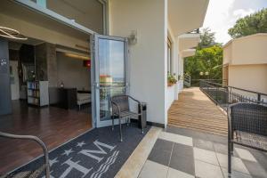 a balcony of a building with a chair and a desk at Hotel Mediterraneo in Cavi di Lavagna +64 photos