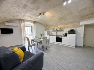 a living room with a couch and a table at Aquamirae - Historic home with panoramic balcony - Affitti Brevi Italia in Gravina in Puglia