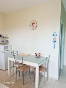 a kitchen with a white table and chairs at IRIA Beach in Iria