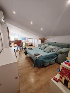 a living room with a large bed and a couch at Casa Santa Creu - Private family villa in nature in Piera +44 photos
