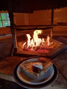 a slice of pizza on a plate in an oven at Paljarinne in Hulmi