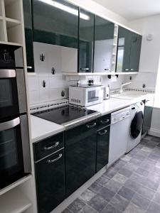 a kitchen with a sink and a stove top oven at Historic central apartment in Castlehill Mansions in Campbeltown