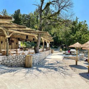 a restaurant with a stone wall and umbrellas at Apartment Lana Maris studio 2 - 200m from beach, terrace with sea view, wi-fi and free parking in Dramalj
