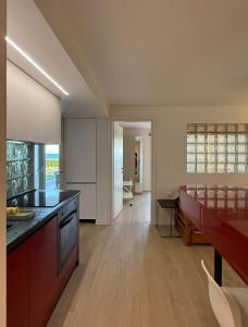 a kitchen with a table and a dining room at apt al mare n22 in Epanomi