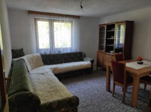 a living room with a couch and a table at Apartman Džanan in Jajce