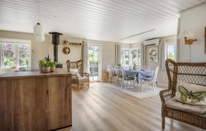 a kitchen and living room with a table and chairs at Nice Home In Haderslev With Wifi in Haderslev