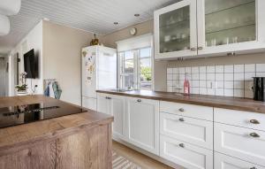 a kitchen with white cabinets and a refrigerator at Nice Home In Haderslev With Wifi in Haderslev
