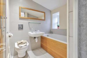 a bathroom with a sink and a toilet and a bath tub at Inglenook a Wandylaw Cottage, a cosy one too in Wandylaw +13 photos