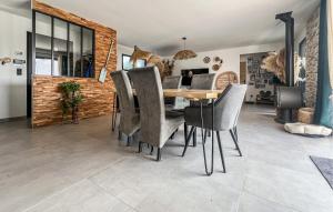 a dining room with a wooden table and chairs at Cozy Home In Saint-Césaire-De-Gauzi in Saint-Césaire-de-Gauzignan