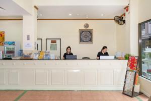 two women sitting at a counter in a store at Patong Central Residence & Apartment in Patong Beach
