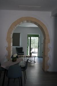 an archway in a room with a table and chairs at Casa di Keti - Modern Home with Private Yard ,3 Min to the Beach in Chania +30 photos