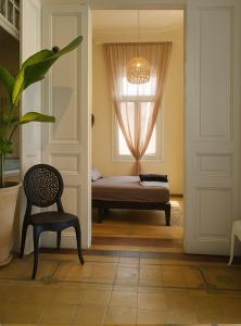 a room with a door and a chair and a window at Villa ZeN- with Private garden and beach in Samos