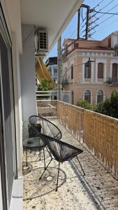 a chair sitting on the balcony of a house at Apartment 34 in Kalamata