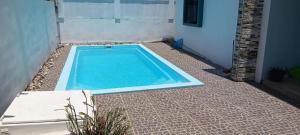 a small swimming pool in the middle of a yard at Rose villa in Pereybere