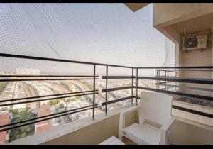 a white chair sitting on top of a balcony at cozy place-paramount golf forest in Greater Noida