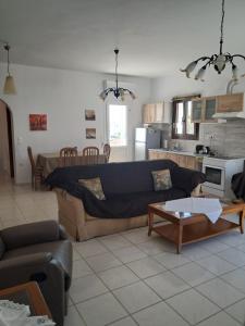 a living room with a couch and a table at Magy's house in Batsi