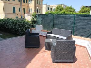 a patio with two chairs and a table and chairs at Il gelsomino in Manziana
