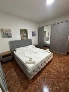 a bedroom with a large bed in a room at Apartment Radhima in Vlorë