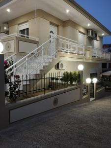 a building with a staircase in front of it at Villa Evdokia in Limenaria