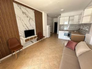 a living room with a couch and a kitchen at Horizont Apartments in Sunny Beach
