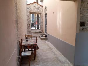 a room with a table and chairs and a window at Aggeliki in Samos