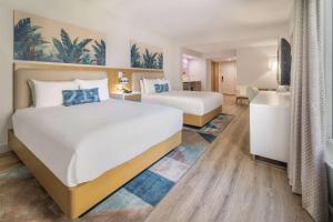 A bed or beds in a room at Radisson Resort Miami Beach