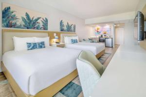 A bed or beds in a room at Radisson Resort Miami Beach