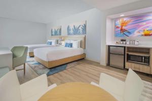 A bed or beds in a room at Radisson Resort Miami Beach