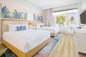 A bed or beds in a room at Radisson Resort Miami Beach
