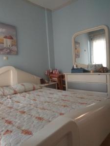 a bedroom with a large bed and a mirror at Nea Augousta in Naousa +6 photos