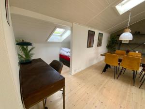 a dining room and living room with a table and chairs at Holiday home Ejby Ådal in Kirke-Hyllinge