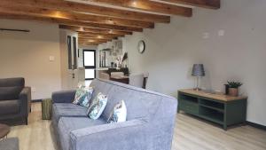 a living room with a blue couch and a table at The Karoo Condo in Montagu