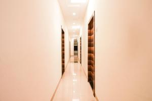 a long corridor with wine bottles on the walls at Hotel O Unique Inn in Dhule