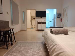 a living room with two beds and a kitchen at The Blue Gate 2 in Muscat