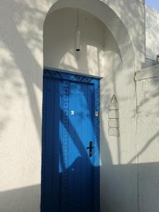 a blue door in a white wall at The Blue Gate 2 in Muscat