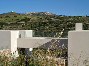 a white house with a view of a hill at Pezoules House II in Lefkes