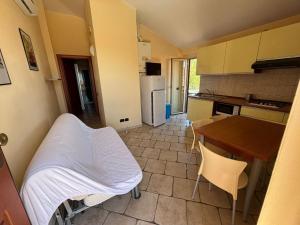 a kitchen with a bed in the middle of a room at Residence IL BORGO 38 in Tortoreto Lido