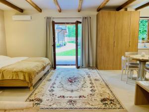 a bedroom with a bed and a door with a rug at Noclegi Na Górze - Obrocz 116 in Obrocz