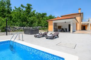 a villa with a swimming pool and a house at Villa Laura by Briskva in Ripenda Kras
