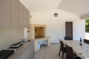 a kitchen with a table and a dining room at Villa Laura by Briskva in Ripenda Kras