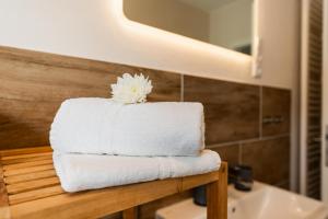 a stack of towels sitting on a counter in a bathroom at Ferienhaus Primavera in Mörsdorf +35 photos