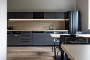 a kitchen with stainless steel appliances and tables at iNTEC NOCLEGI in Gniezno