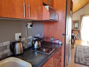 a kitchen with a stove and a sink at The Loft Getaway in Clarens