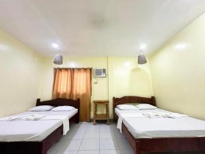 Ένα ή περισσότερα κρεβάτια σε δωμάτιο στο Panagsama Tourist Inn