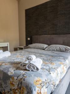 a bedroom with a bed with a towel on it at B&B Roseal in Brusciano +20 photos