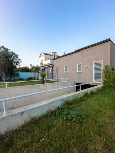 a building with a grass field in front of it at B&B Roseal in Brusciano