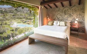 A bed or beds in a room at Tenuta San Masseo - boutique farm resort & SPA